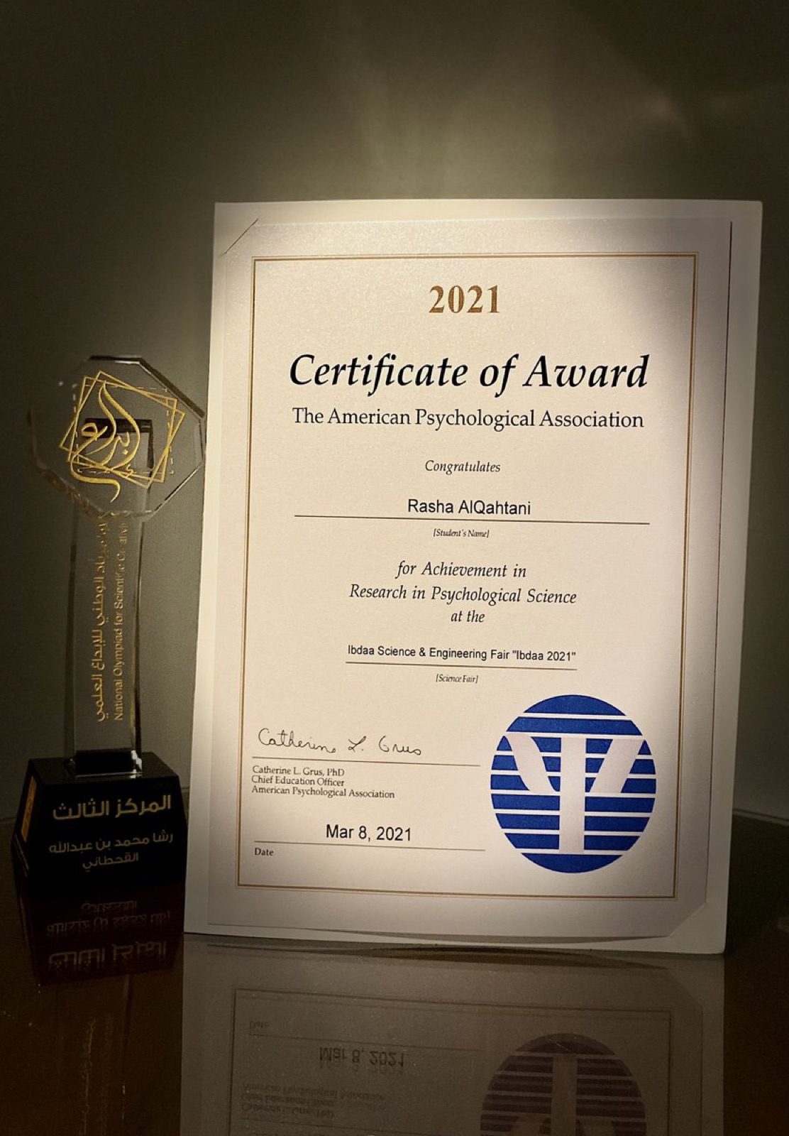 The APA Certificate of Award beside the Ibdaa trophy
